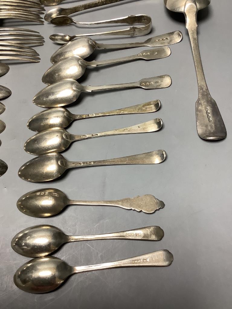 A small collection of silver fiddle pattern flatware, two pairs of sugar tongs and sundry silver coffee and condiment spoons, Georgian and later, approximately 18oz